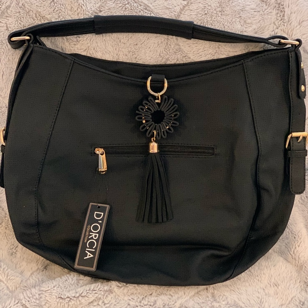 NWT D’ORICA black bag with long adjustable strap. Gold accents and flower tassel